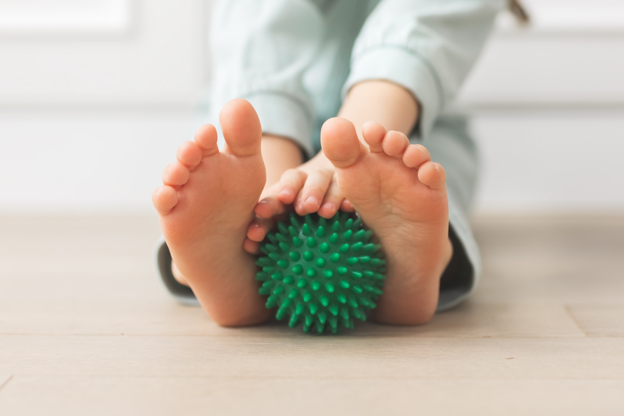 kid holding massage ball physical therapy and massage for development neuro psychology